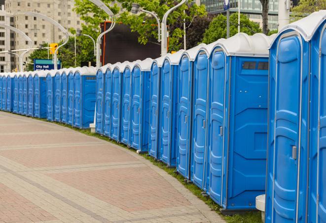 a row of portable restrooms set up for a large athletic event, allowing participants and spectators to easily take care of their needs in Long Lake