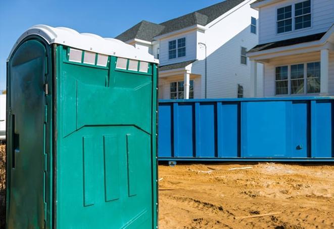 a row of porta potties located at a busy work site